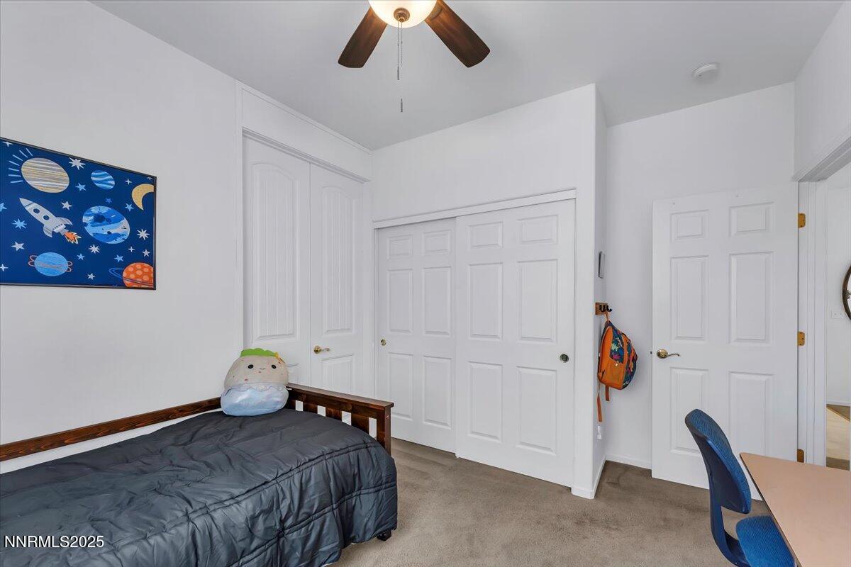 5921 Sapphire Ridge Court Reno, NV 89523 - Photo 19 of 31 a bedroom with a bed and a chandelier