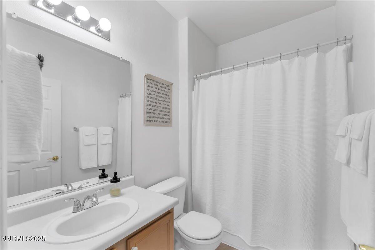 5921 Sapphire Ridge Court Reno, NV 89523 - Photo 20 of 31 a bathroom with a granite countertop sink toilet and a mirror