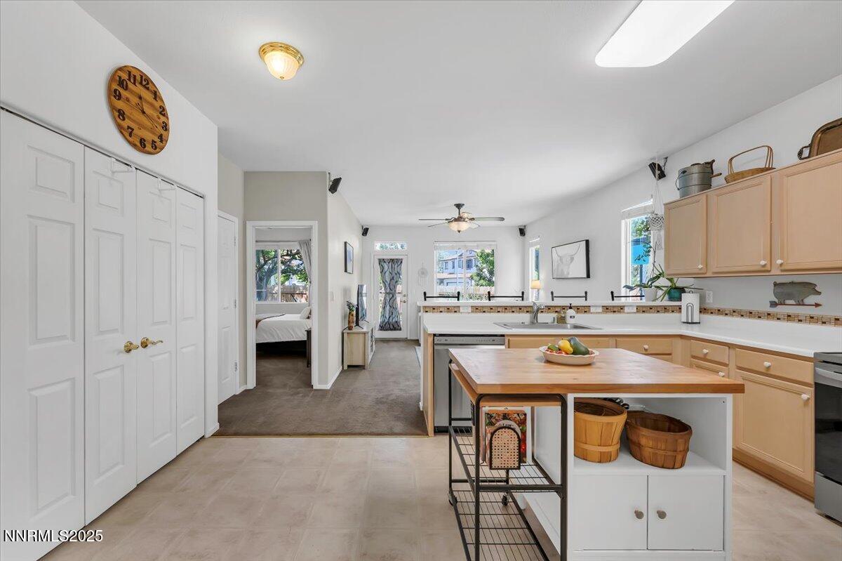 5921 Sapphire Ridge Court Reno, NV 89523 - Photo 6 of 31 a kitchen with kitchen island a stove and a refrigerator