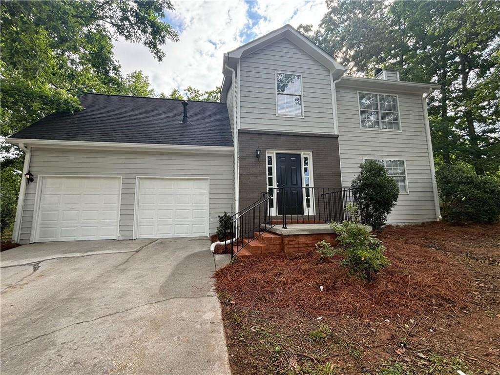 3746 Tarrytown Way Decatur, GA 30034 - Photo 1 of 1 a front view of a house with a yard and garage