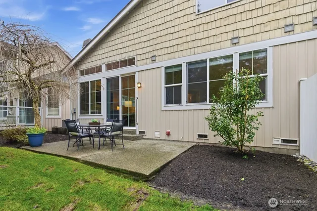 a view of a house with patio and a yard