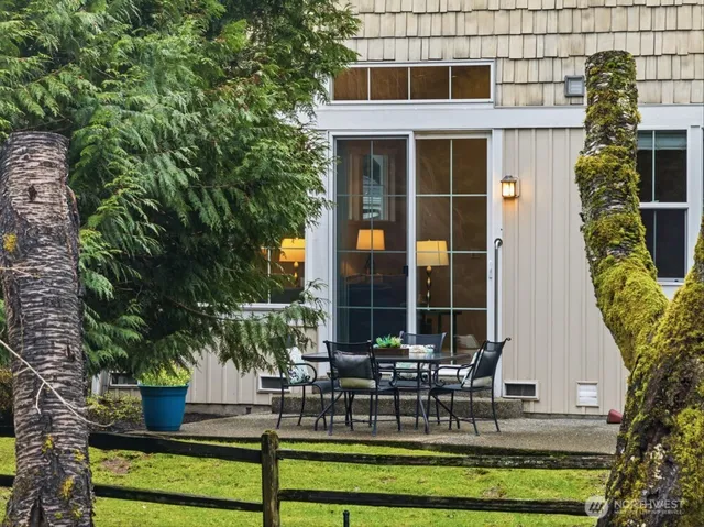 a view of a building with sitting area and garden