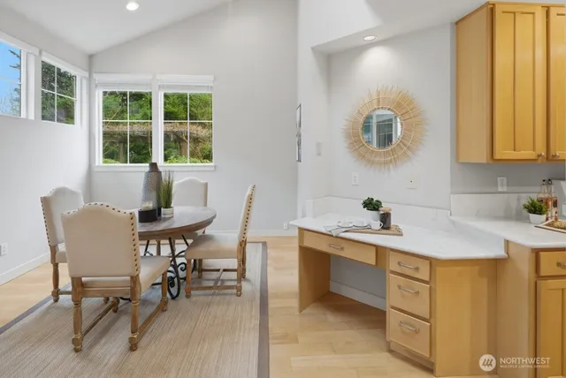a kitchen with a table chairs and a sink