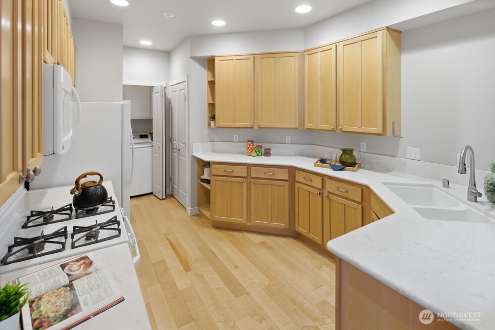 120 Newport Way Northwest, Unit 9 Issaquah, WA 98027 - Photo 18 of 40 a kitchen with a sink a stove and a refrigerator