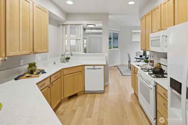 a kitchen with stainless steel appliances granite countertop a stove a sink dishwasher and a refrigerator