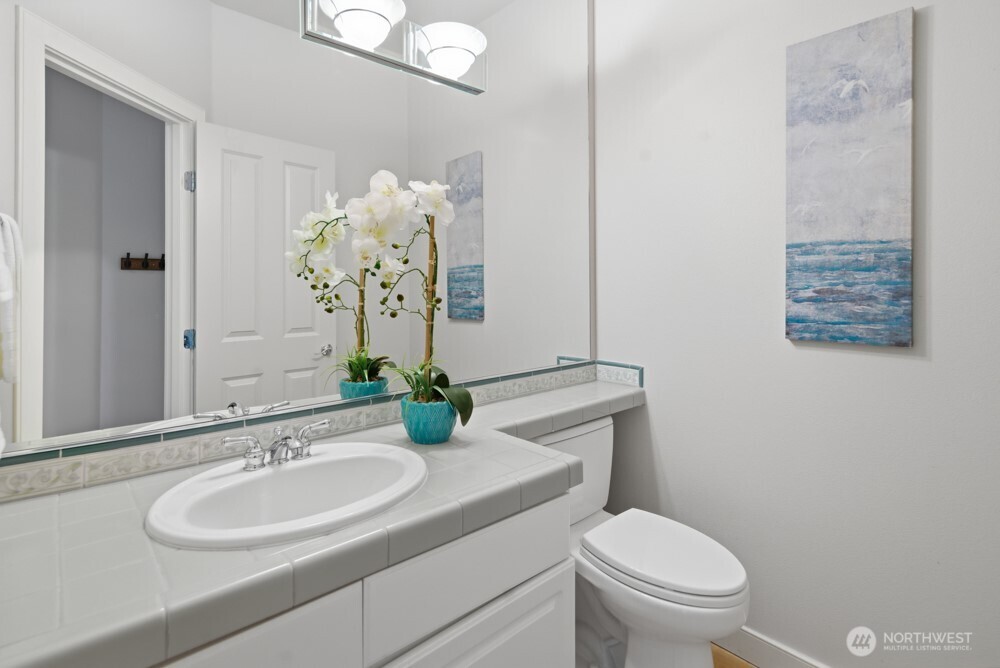 120 Newport Way Northwest, Unit 9 Issaquah, WA 98027 - Photo 22 of 40 a bathroom with a sink toilet and a mirror