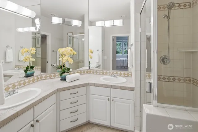 a bathroom with a granite countertop sink mirror and shower