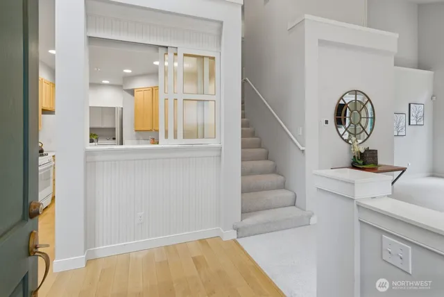 a view of entryway and hall with wooden floor