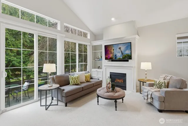 a living room with furniture a fireplace and a flat screen tv