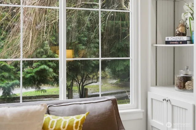 a view of a balcony and a floor to ceiling window next to a yard