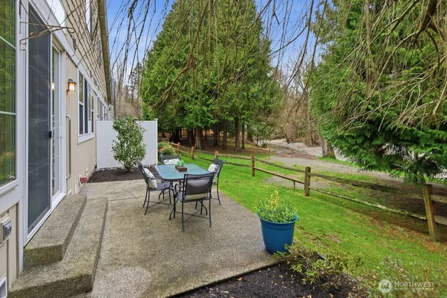 a view of a backyard with sitting area and garden