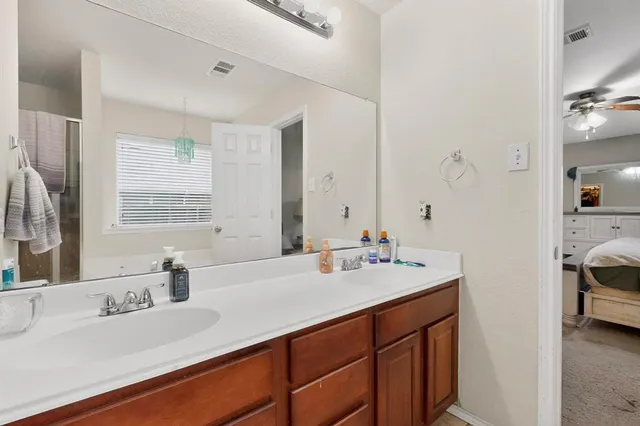 a bathroom with a sink double vanity and a mirror