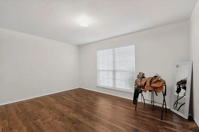 a view of a livingroom with wooden floor and a window