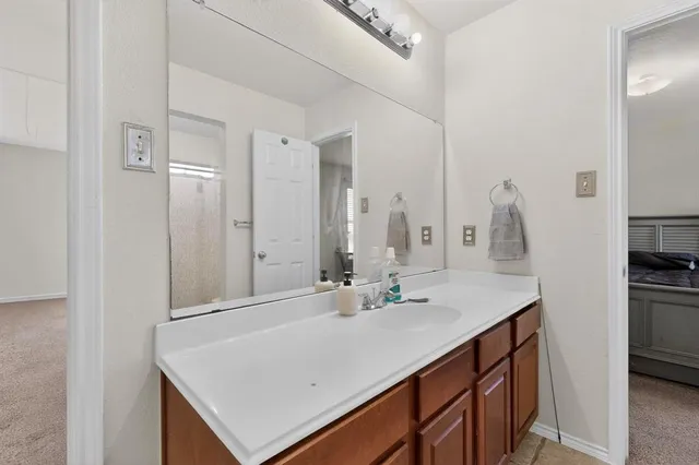 a bathroom with a sink vanity and a mirror