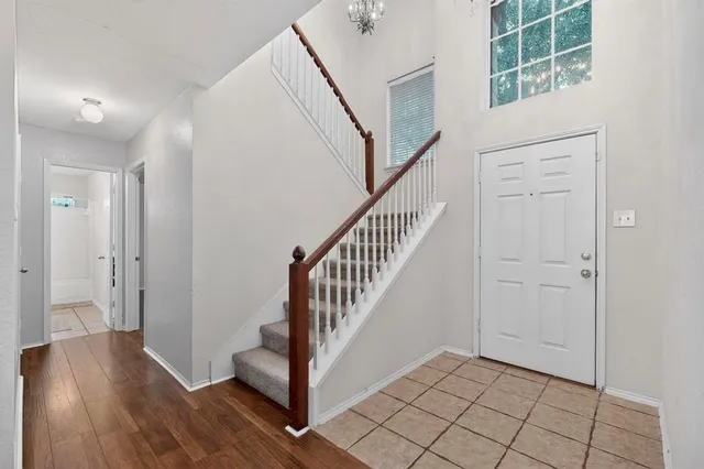 a view of an entryway with wooden floor and staircase