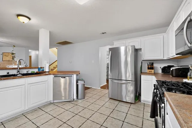 a kitchen with granite countertop a refrigerator and a sink