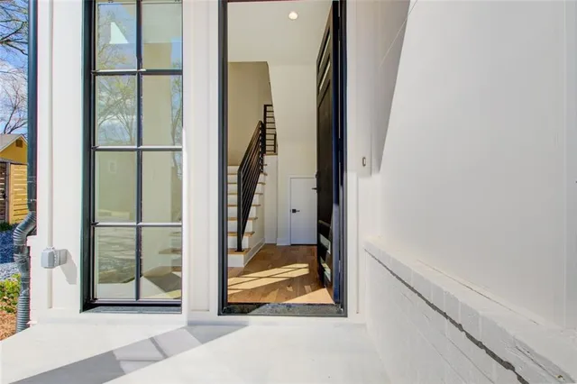 a view of a hallway with wooden floor and glass door