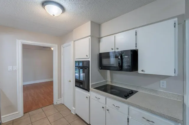 a kitchen with stainless steel appliances a sink and refrigerator
