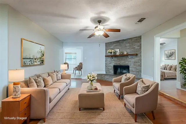 a living room with furniture a fireplace and a flat screen tv