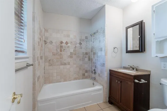 a bathroom with a toilet sink vanity and mirror