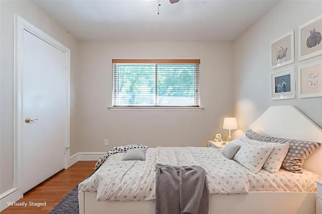 a bed sitting in a bedroom next to a window