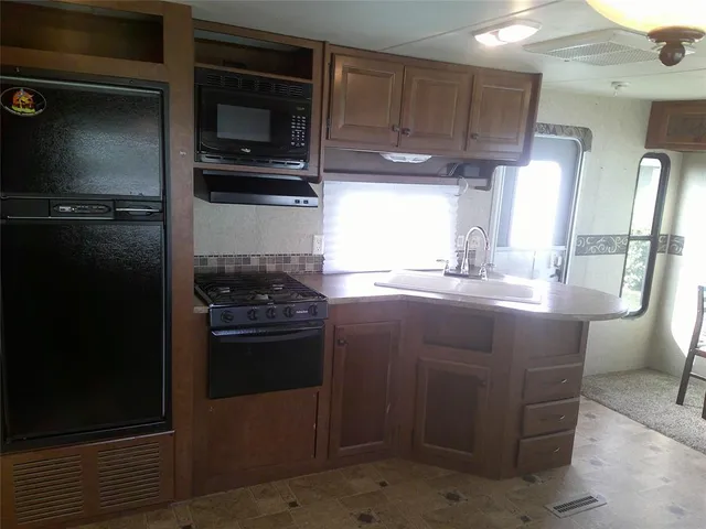a kitchen with a sink and stainless steel appliances