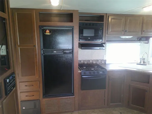 a kitchen with a refrigerator and window