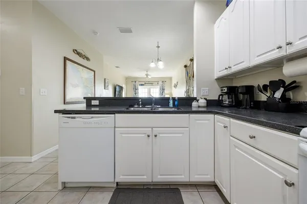 a kitchen with cabinets and window