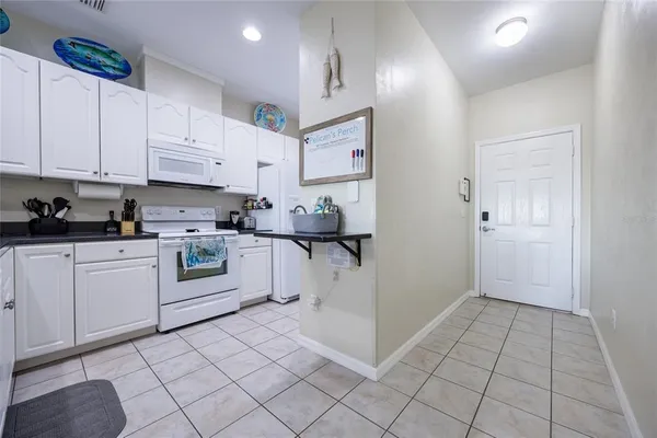 a hallway with a dining table and cabinets