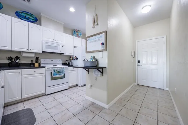 a hallway with a dining table and cabinets
