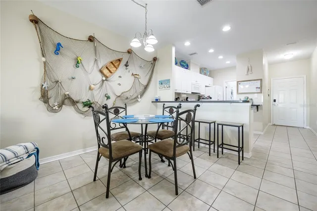 a view of a dining room with furniture and a chandelier