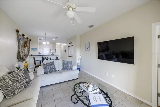 a spacious bedroom with a large bed a chandelier and a mirror