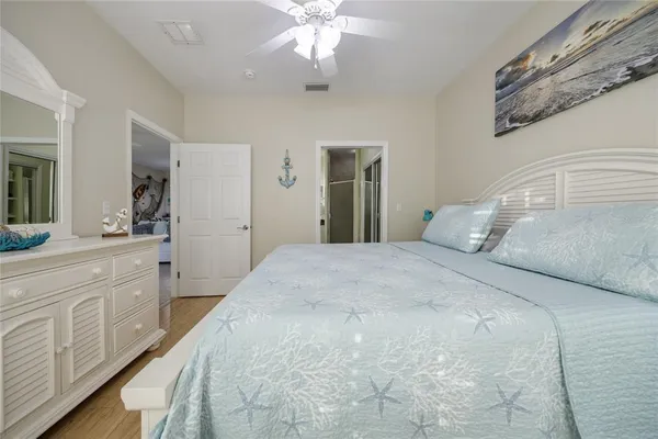 a spacious bedroom with a large bed and a mirror