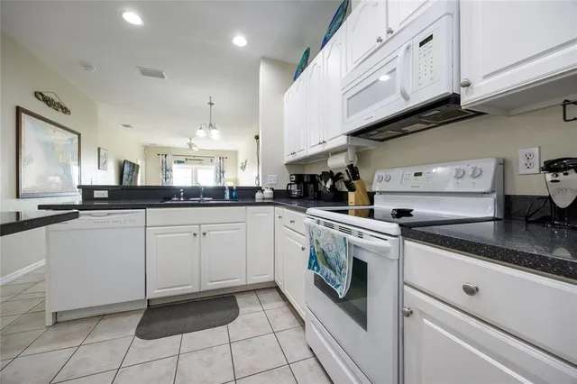 a kitchen with a white cabinets and white appliances