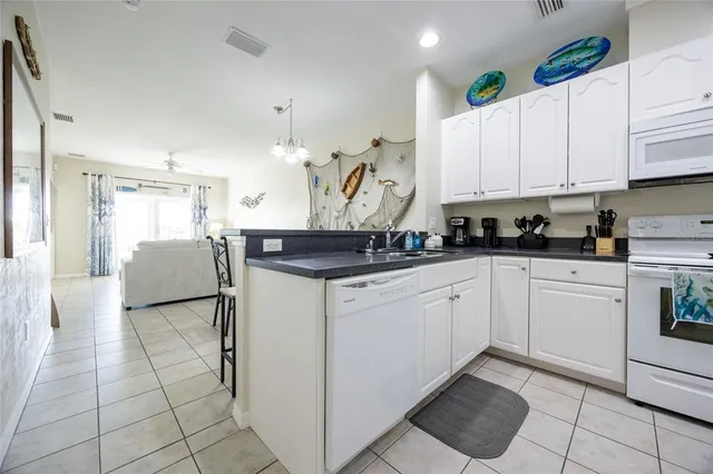 a kitchen with white cabinets