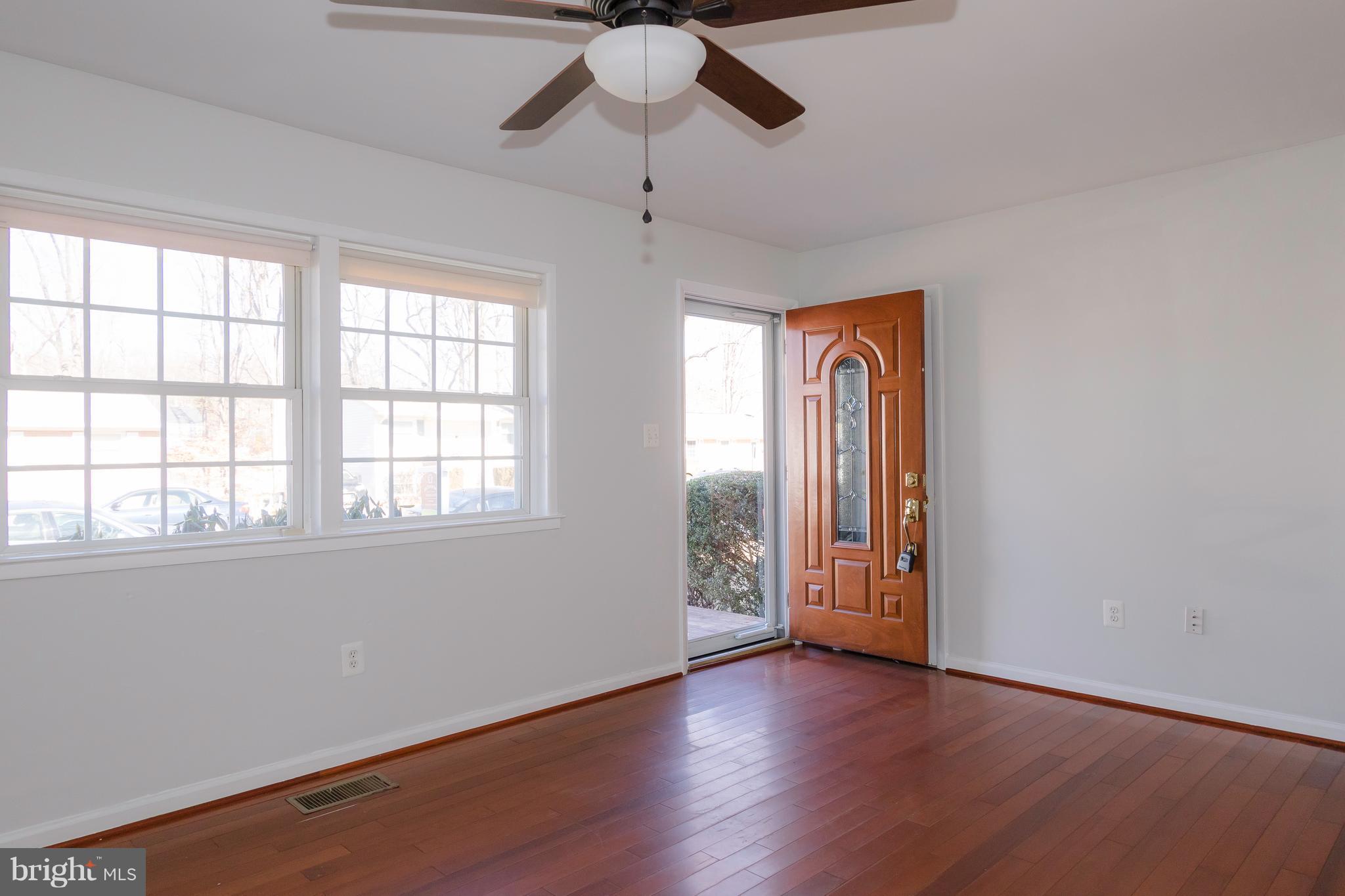 4141 Granby Road Woodbridge, VA 22193 - Photo 3 of 30 an empty room with wooden floor chandelier fan and windows