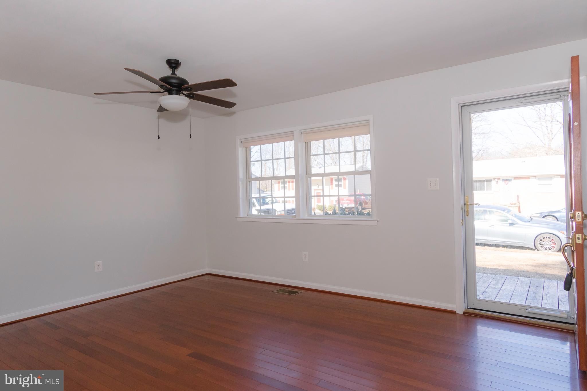 4141 Granby Road Woodbridge, VA 22193 - Photo 4 of 30 an empty room with wooden floor fan and windows