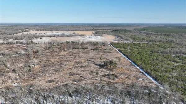 a view of a dry yard with wooden floor and a city view