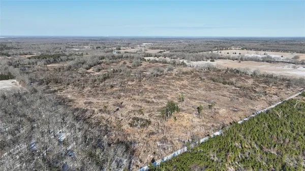 a view of a big yard with lots of green space