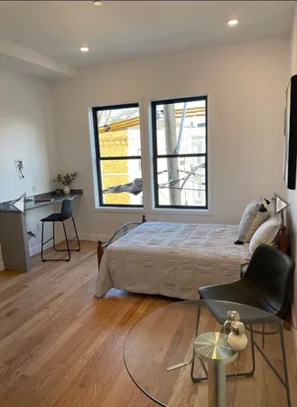 a bedroom with a bed and a chair