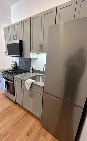 a kitchen with a sink appliances and cabinets