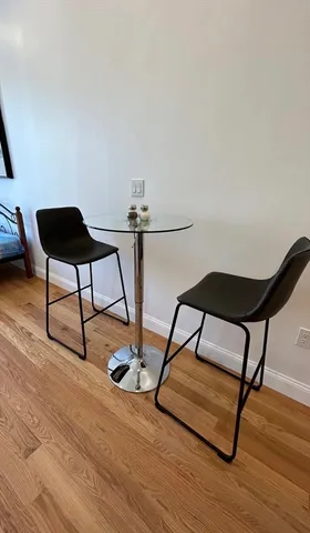 a living room with a couch and wooden floor