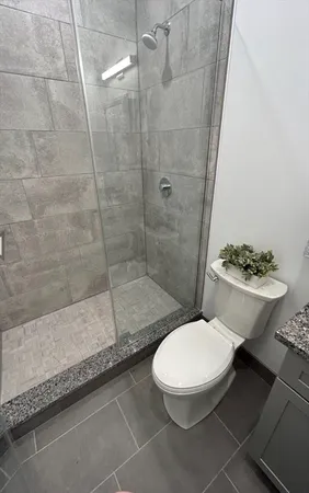 a white toilet sitting next to a bathroom sink