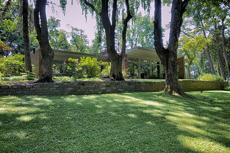 500 Fairview Road Pittsburgh, PA 15238 - Photo 2 of 19 The side of the home is all windows, allowing Million Dollar Views from every room.. Mature trees line a stone fence, perfect for looking at and enjoying your morning coffee or maybe even a glass of wine after work.