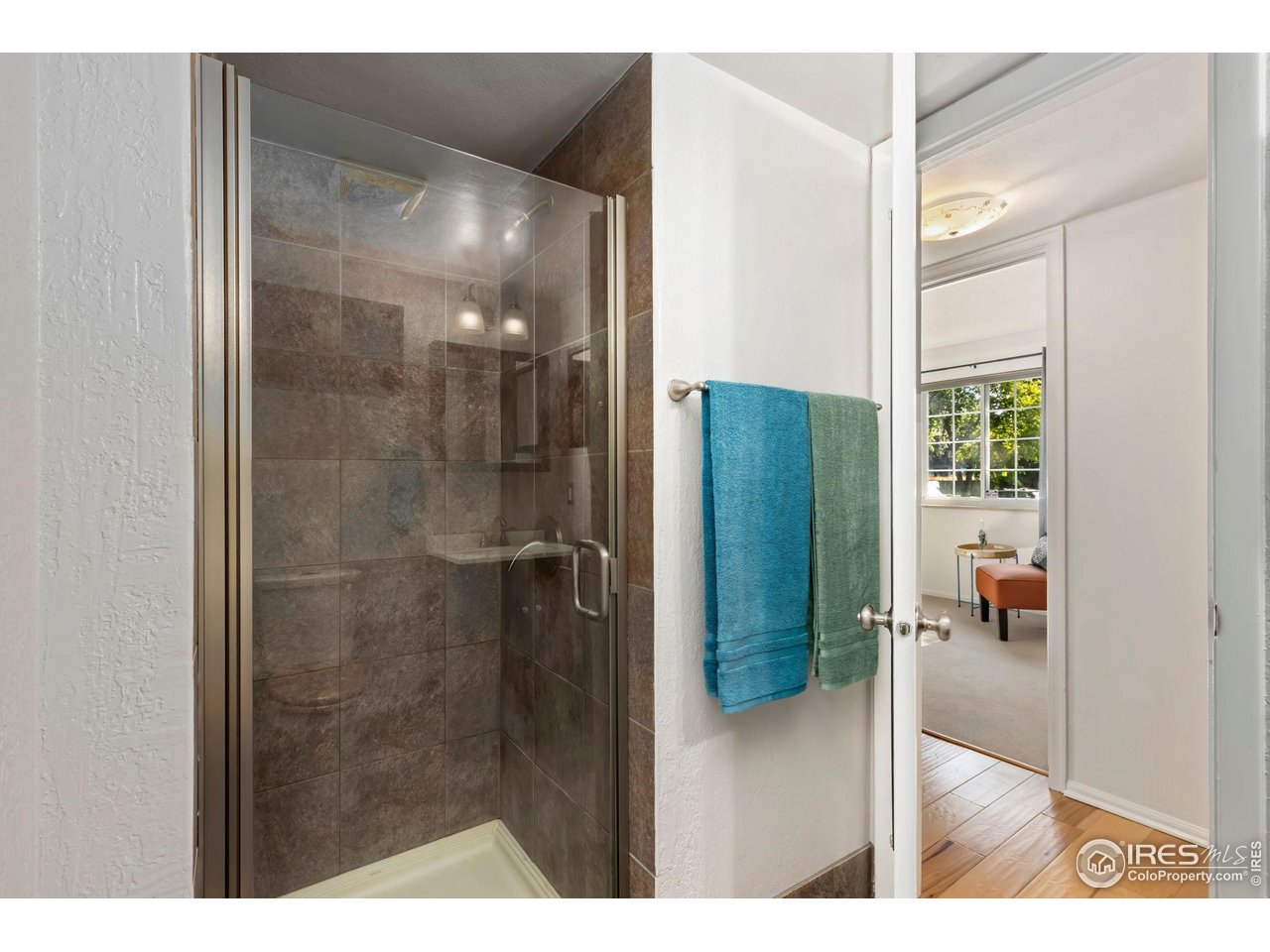 3250 Oneal Circle, Unit 10 Boulder, CO 80301 - Photo 11 of 20 a bathroom with a glass shower door and a mirror