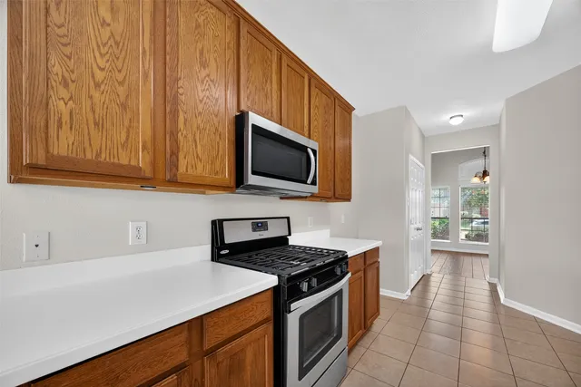 a kitchen with stainless steel appliances a stove microwave and cabinets