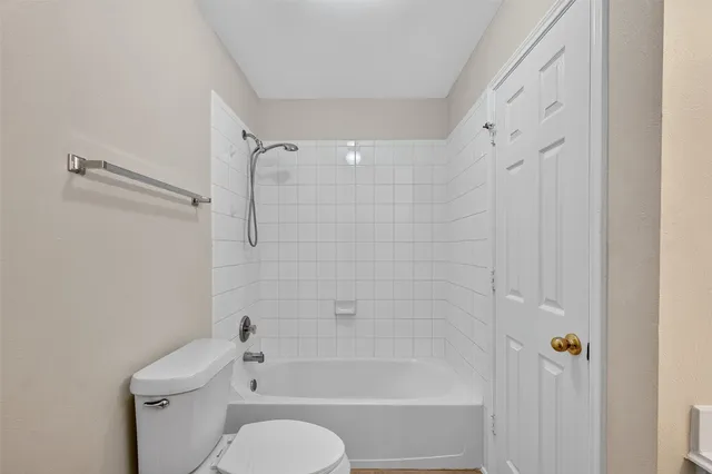 a bathroom with a toilet and a bathtub