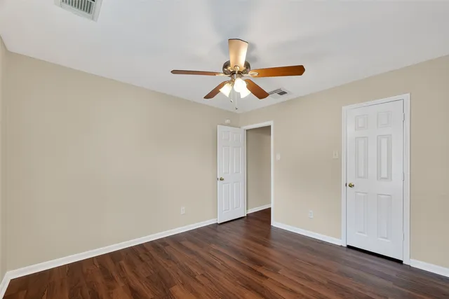 a view of a room with wooden floor