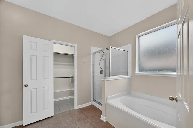 a bathroom with a bathtub and a shower