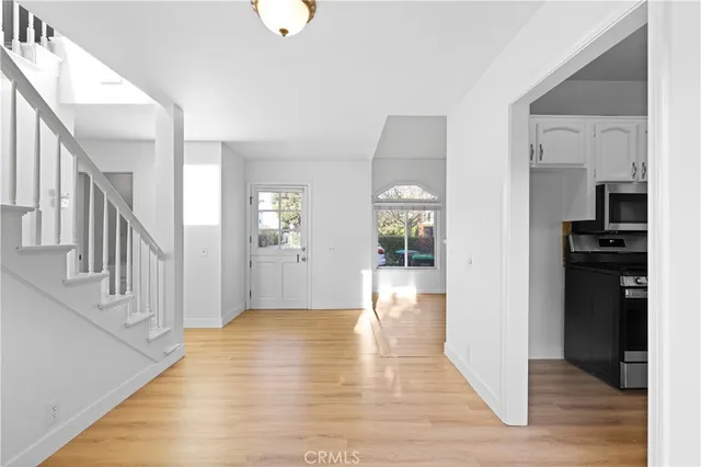 a view of an entryway with wooden floor and a livingroom